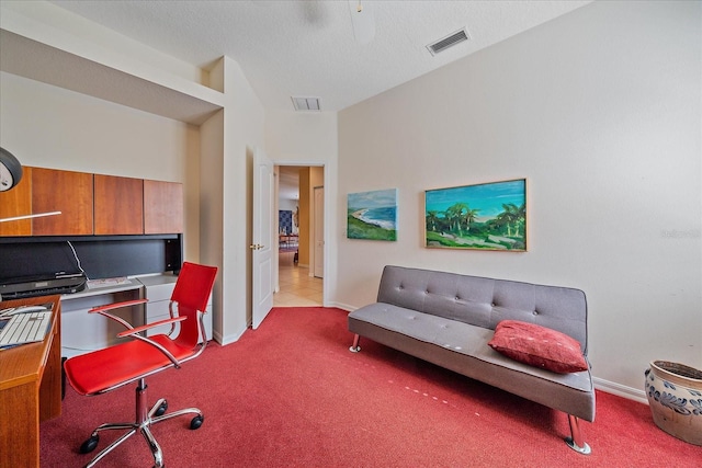 carpeted home office with a textured ceiling