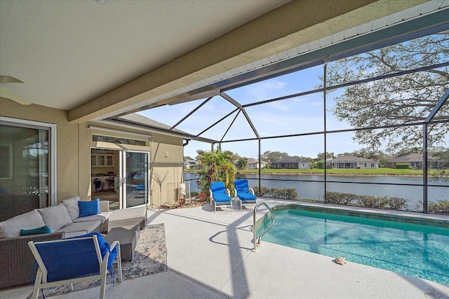 view of pool featuring a water view, glass enclosure, a patio area, and outdoor lounge area