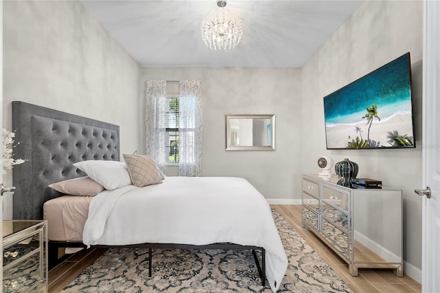 bedroom with a notable chandelier and wood-type flooring