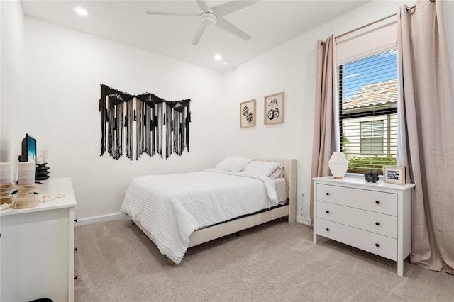 bedroom featuring ceiling fan and light carpet