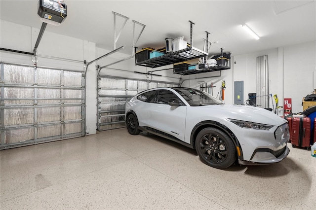 garage with a garage door opener and electric panel