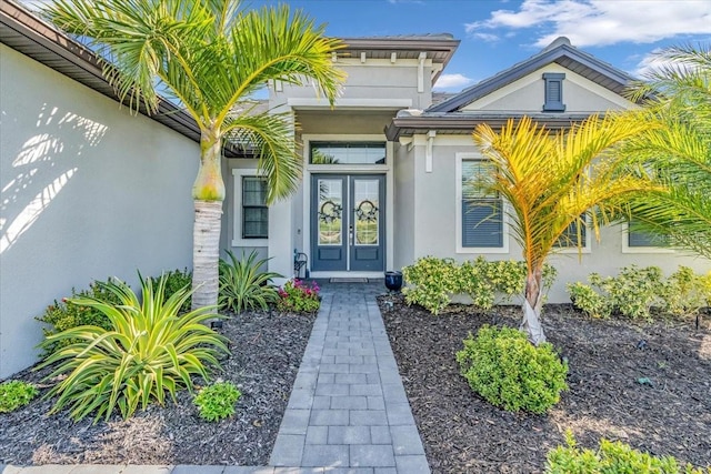 property entrance with french doors and stucco siding