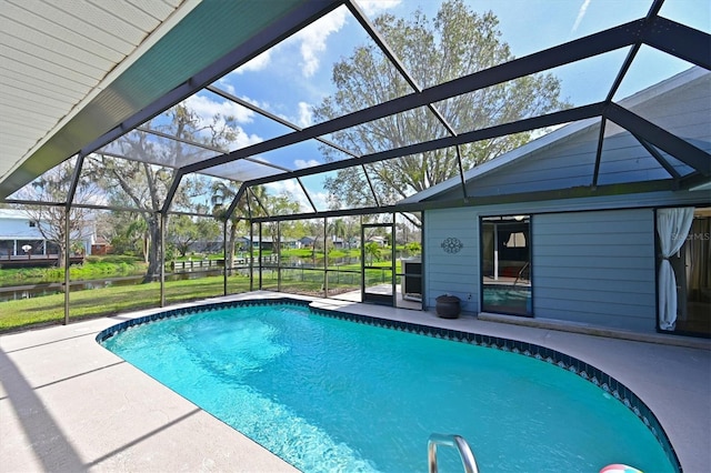 pool with a lanai and a patio area