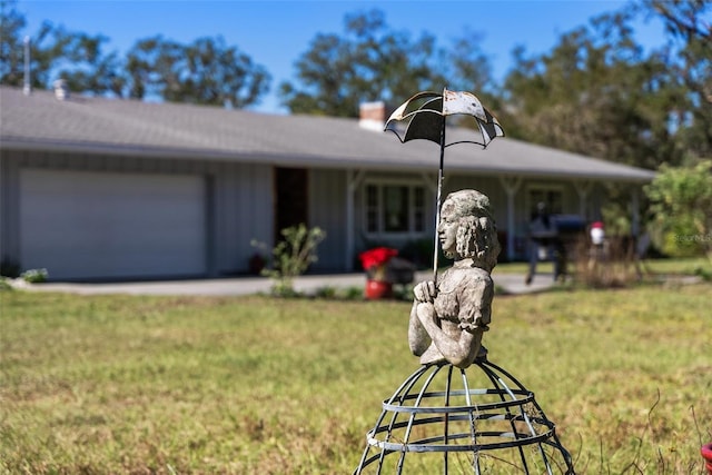 view of front of home featuring a garage and a front lawn