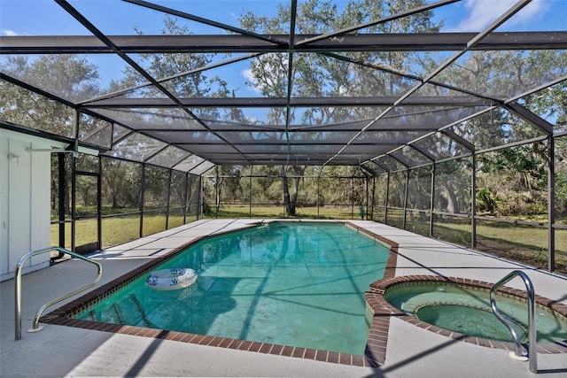 view of swimming pool featuring a pool with connected hot tub, a patio, and a lanai