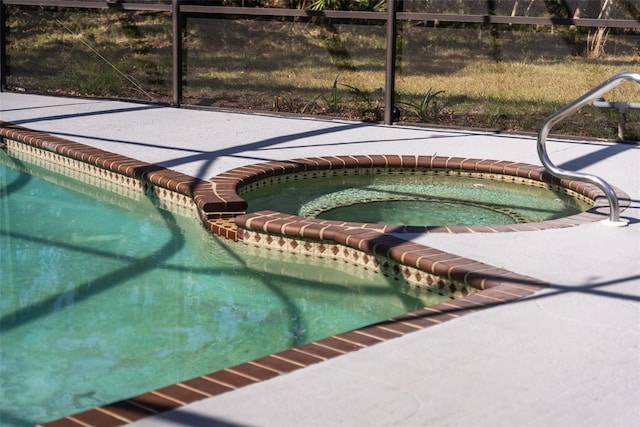 view of pool featuring a pool with connected hot tub