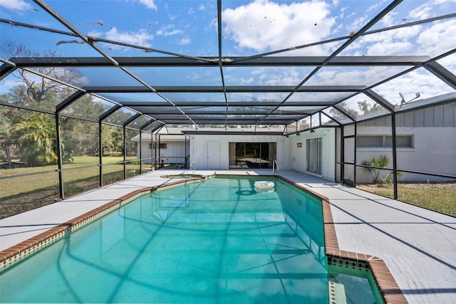 outdoor pool featuring glass enclosure and a patio area