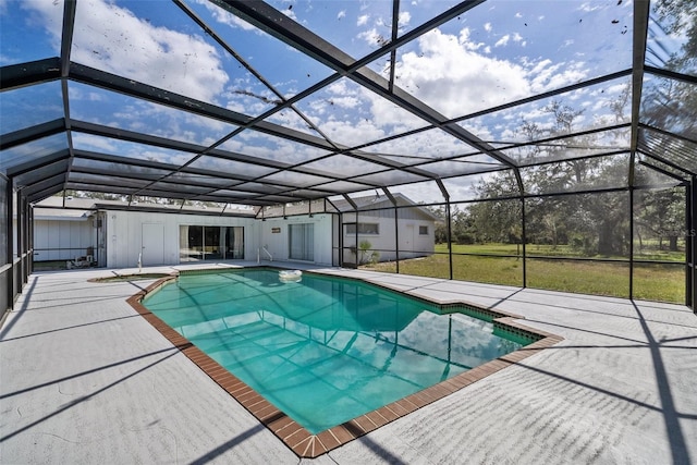 pool featuring a lanai, a patio, and a lawn