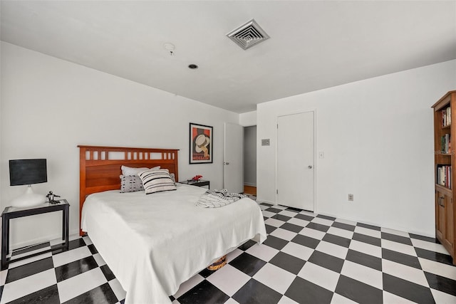 bedroom with dark floors and visible vents