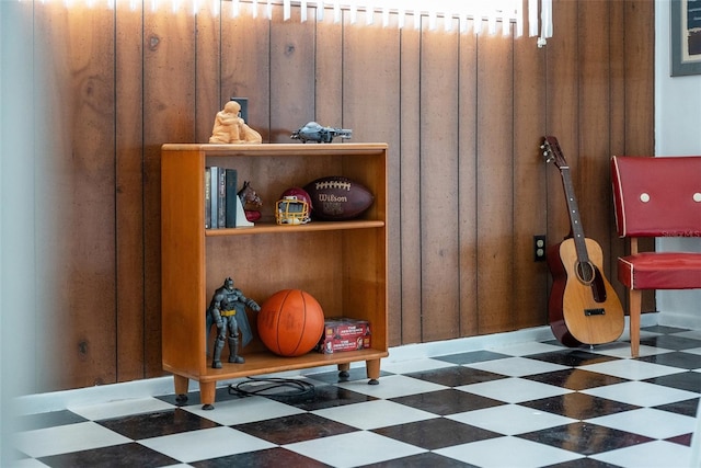 rec room featuring dark floors and wood walls