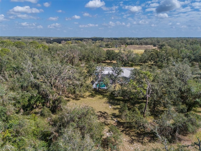 bird's eye view featuring a wooded view