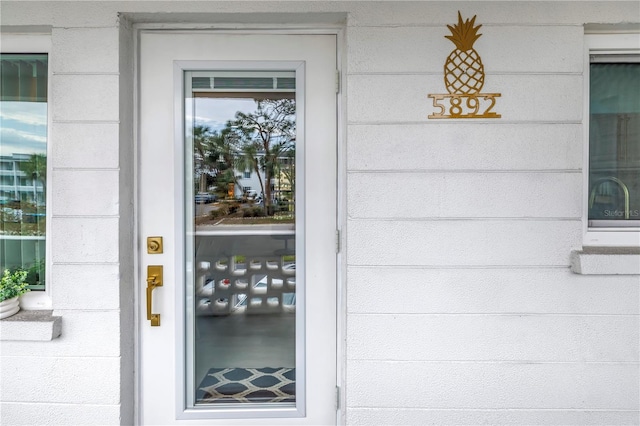 view of exterior entry with concrete block siding