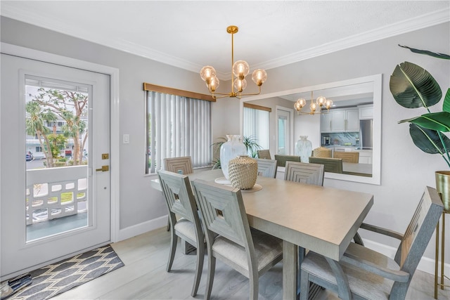 dining space with a chandelier, baseboards, light wood-style flooring, and crown molding