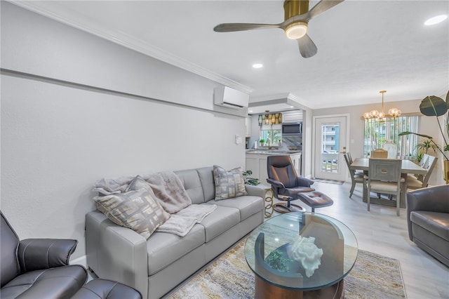 living area featuring ceiling fan with notable chandelier, a wall mounted AC, recessed lighting, and crown molding