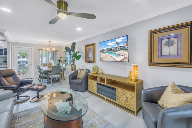 living area featuring recessed lighting, crown molding, baseboards, and ceiling fan with notable chandelier