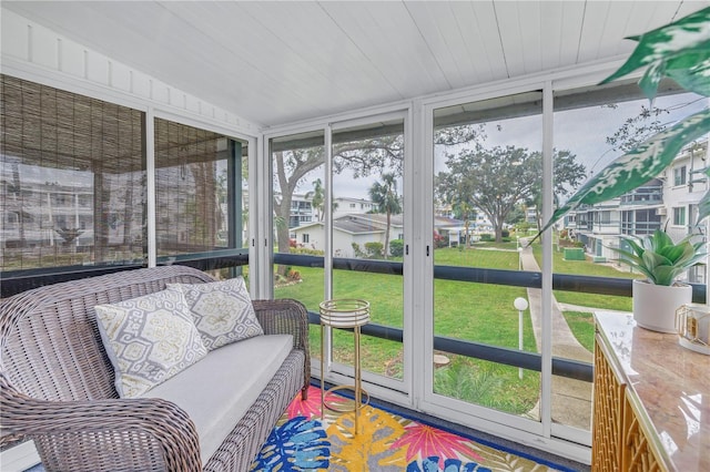 sunroom featuring wood ceiling and a wealth of natural light