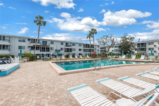 community pool with a patio area