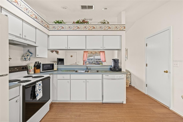 kitchen featuring under cabinet range hood, white appliances, a sink, visible vents, and white cabinets