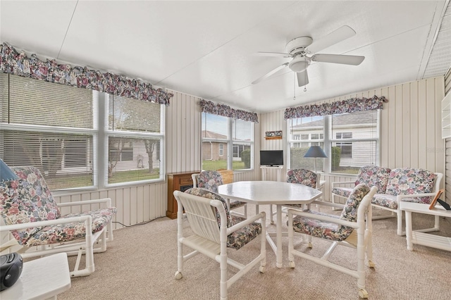 sunroom / solarium with a ceiling fan