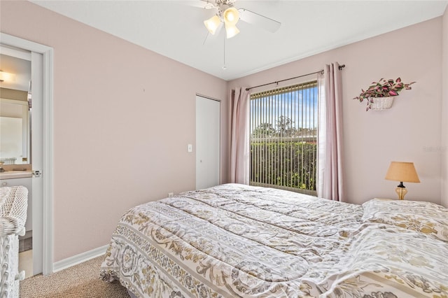 carpeted bedroom with ceiling fan and baseboards