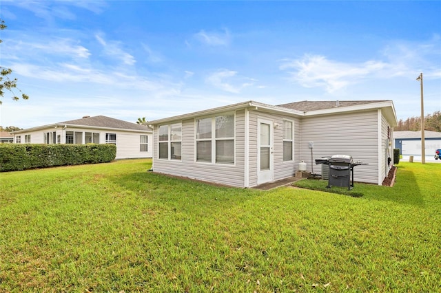 rear view of house with a lawn