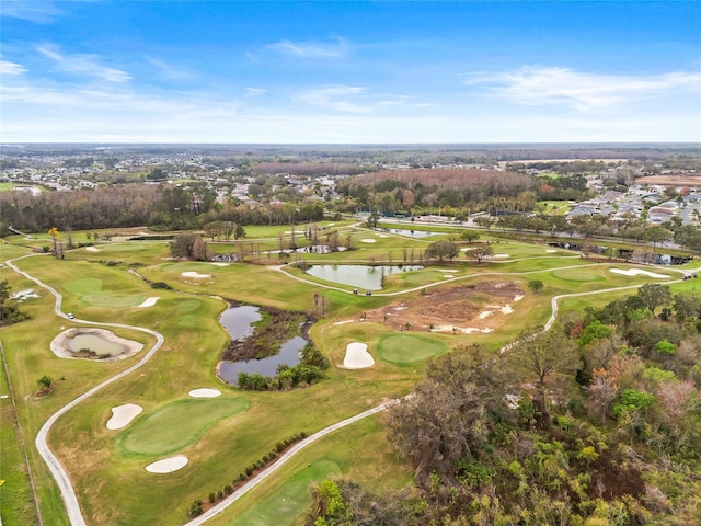 aerial view with golf course view and a water view