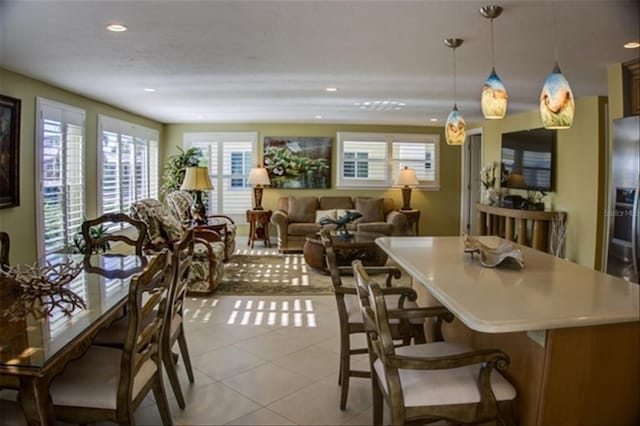 dining room with light tile patterned flooring and recessed lighting