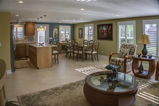 living area with light tile patterned floors, baseboards, and recessed lighting