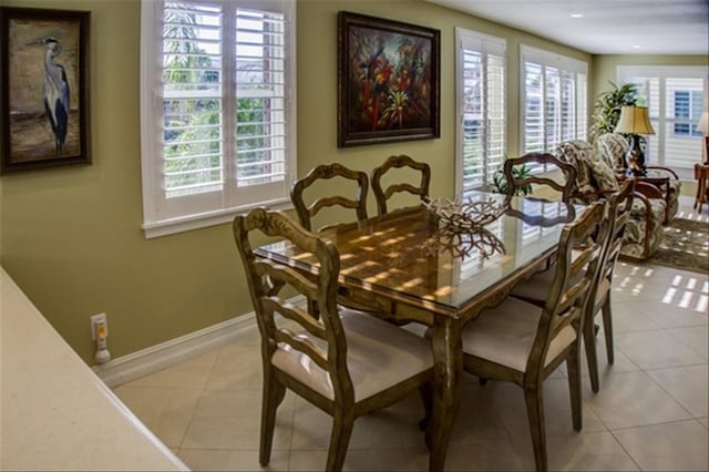 dining room featuring light tile patterned flooring and baseboards