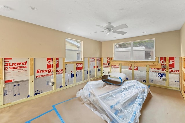 bedroom with ceiling fan and a textured ceiling