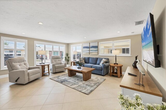 6140 Midnight Pass Rd Unit A10, Sarasota, FL 34242 - living area with healthy amount of natural light, a textured ceiling, light tile patterned floors, and recessed lighting
