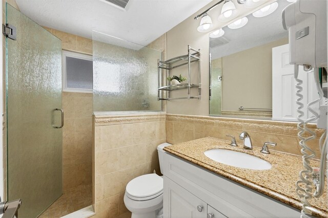 6140 Midnight Pass Rd Unit A10, Sarasota, FL 34242 - bathroom featuring a shower stall, vanity, tile walls, and wainscoting