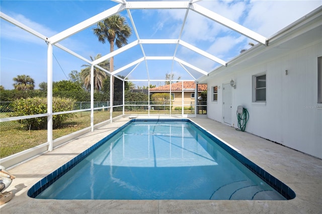 view of pool featuring a patio area and glass enclosure