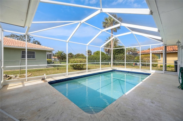 outdoor pool with a lanai and a patio area