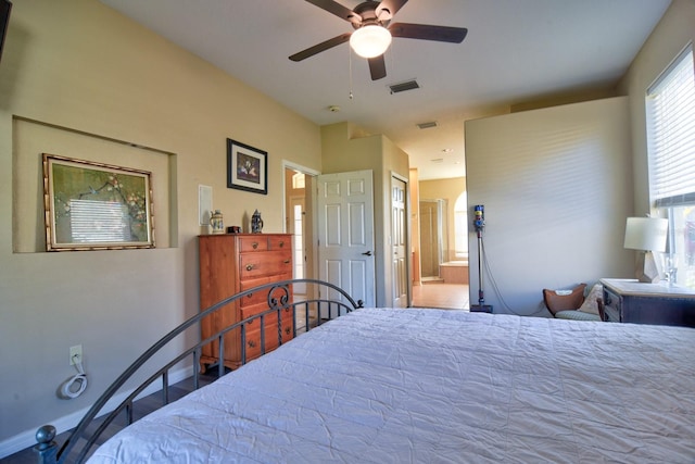 bedroom featuring ceiling fan, connected bathroom, and visible vents