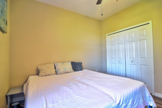 bedroom featuring ceiling fan, baseboards, a closet, and wood finished floors