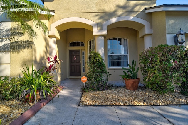 doorway to property with stucco siding