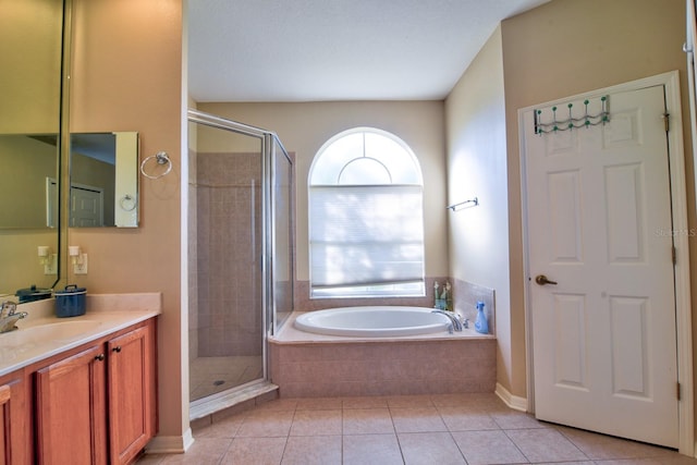 full bath featuring a stall shower, vanity, a bath, and tile patterned floors