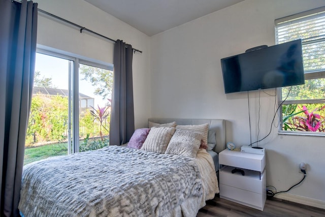 bedroom featuring baseboards and dark wood-type flooring