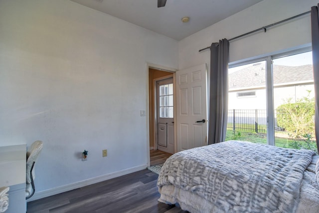 bedroom with dark wood-style floors, access to outside, multiple windows, and baseboards