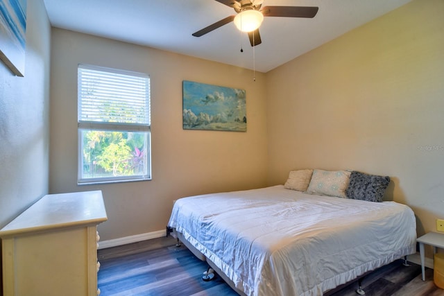 bedroom featuring ceiling fan, dark wood finished floors, and baseboards