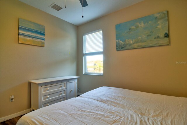 bedroom featuring baseboards, visible vents, and ceiling fan