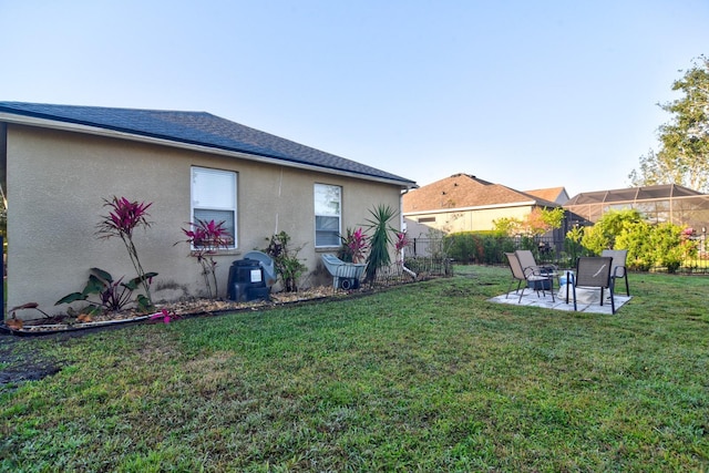 rear view of property with a yard, fence, and stucco siding