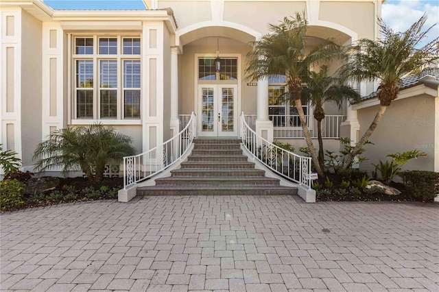 property entrance with french doors and stucco siding