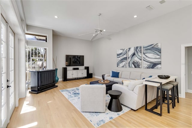 living room featuring recessed lighting, visible vents, baseboards, and wood finished floors