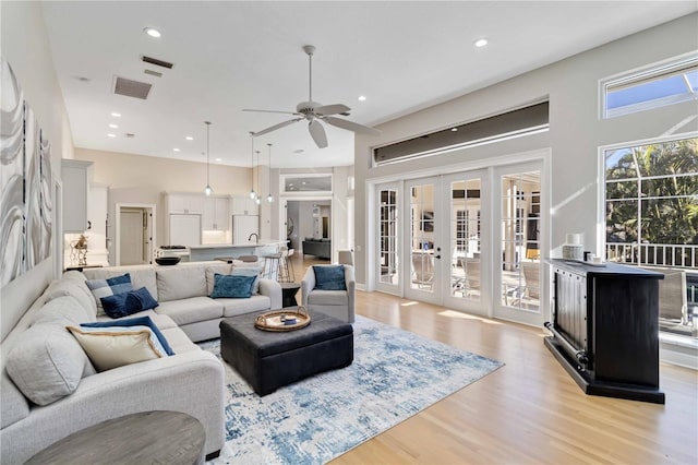 living area featuring visible vents, ceiling fan, french doors, light wood-type flooring, and recessed lighting