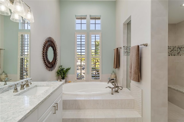 bathroom featuring a tile shower, vanity, and a bath