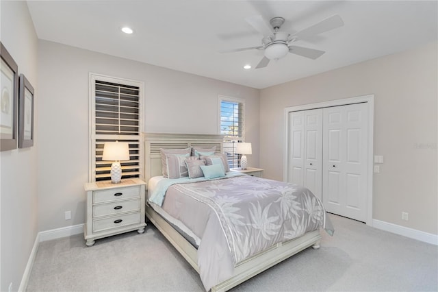 bedroom with baseboards, a closet, recessed lighting, and light colored carpet