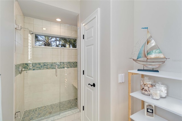 bathroom with a stall shower and recessed lighting