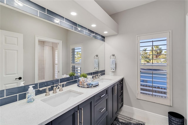 full bathroom with recessed lighting, a sink, baseboards, and double vanity